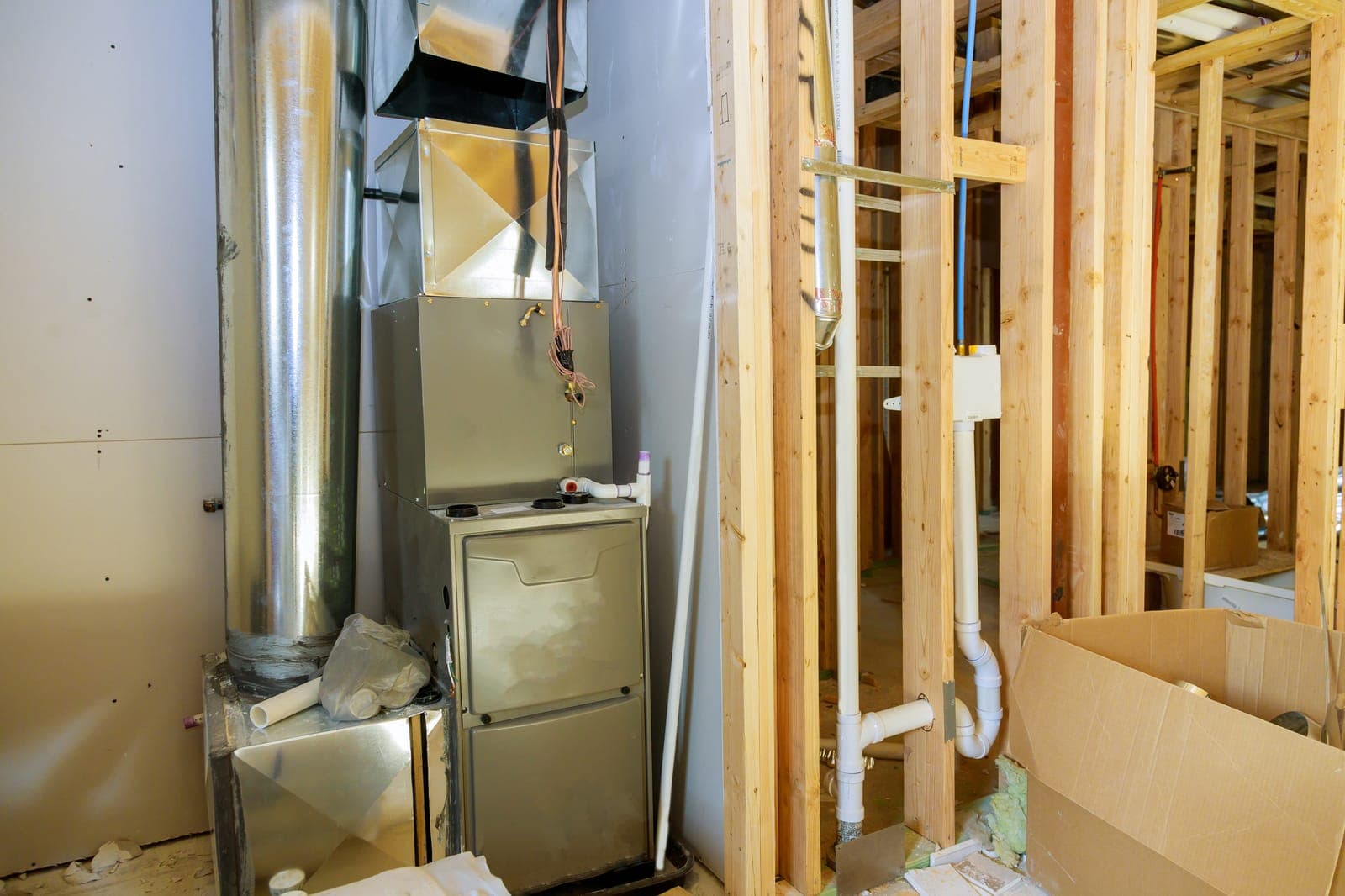 A new furnace and ductwork being installed in a home