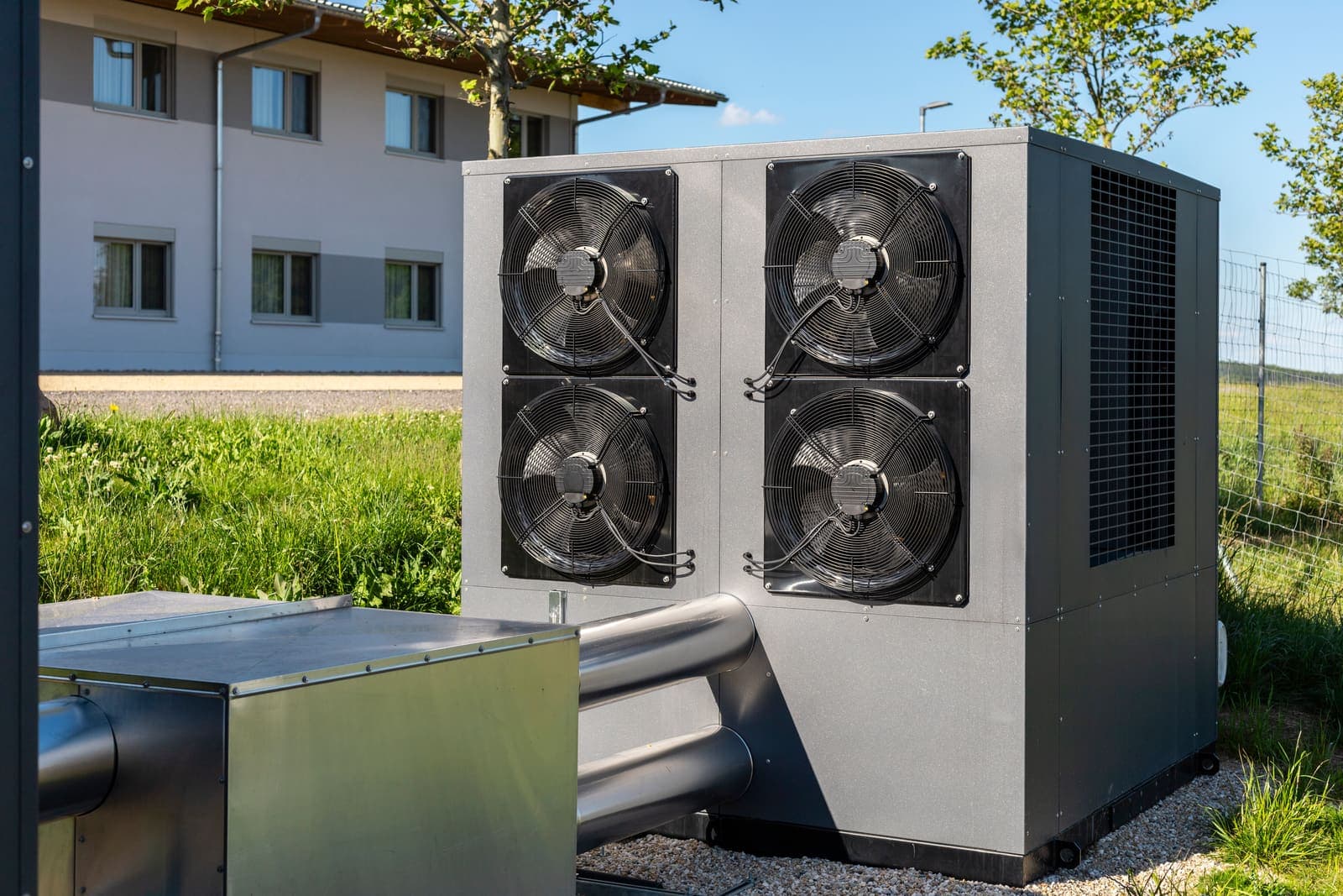 An outdoor heat pump unit beside a home