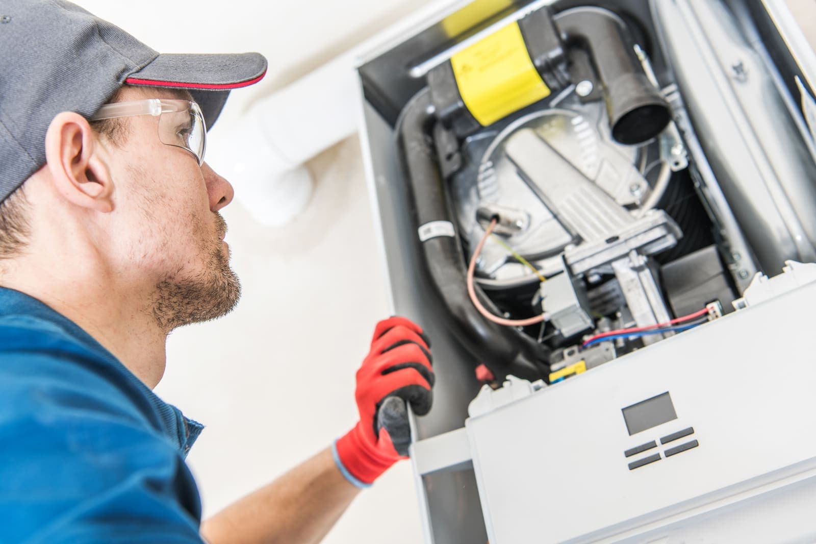 An HVAC technician servicing a home heating system